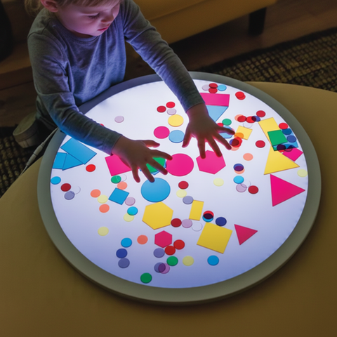 Sensory Specific Products collection — child exploring colourful shapes on a round light panel