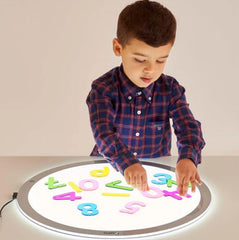 Image of a young child using numbers on a round light up panel