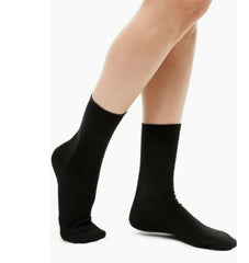 This is an image of a child wearing the Calmcare Adaptive Ankle Length Sensory Socks - black