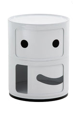 Image of a round storage unit with a smiling face. White unit with black details. Unit is slightly opened at the bottom.