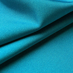 Close-up of turquoise lycra fabric with folds