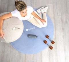 Woman sitting on 120cm stretch mat in periwinkle blue colour 