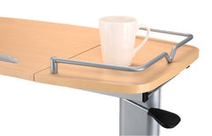 This is an image of an overbed table. It has a split tip top and a rail around it to stop things spilling