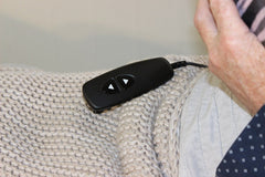  This is an image of the Deluxe Electrical Adjustable Bed Backrest  remote control with someone's hand in the picture
