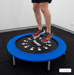 This is an image of a someone jumping on a Mini Trampoline with a red skirt