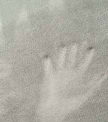 This is an image of a light grey Calming Sensory Touch Mats showing a handprint 