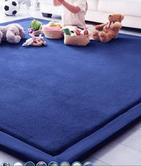 This is an image of a child playing with soft toys on a deep blue  Calming Sensory Tactile Mat
