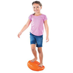 Image of a girl standing on an  Orange  Wobble Cushion