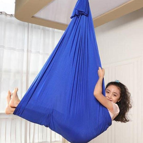 This is an image of a child using a Blue Lycra Therapy Snuggle Sack Kids Swing For Autism