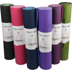 This is an image of Yoga fitness Mats rolled up. The colours are green and black, pink and red, dark blue and light blue, dark purple ad light purple, burgundy and pink.