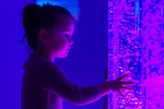 This is an image of a child touching Sensory LED Bubble Tube - great for sensory zones